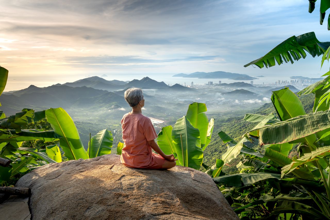 Person meditating on a rock